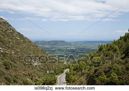 Stock Image - Road through valley. Fotosearch