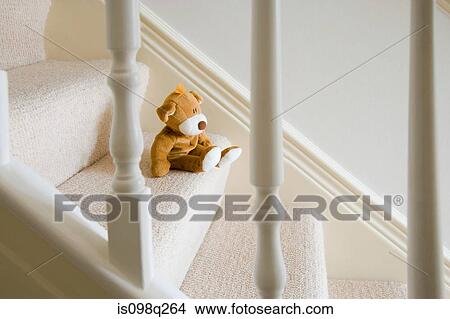 Picture - Soft toy on stairs. Fotosearch