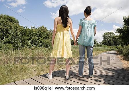 Two women holding hands View Large Photo Image Stock Image - Two women holding hands. Fotosearch