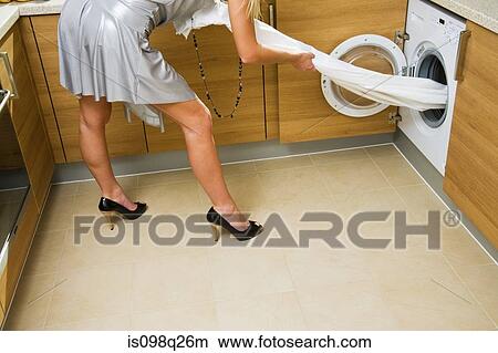 Woman using washing machine View Large Photo Image Picture - Woman using washing machine. Fotosearch
