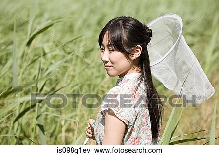 Woman with butterfly net View Large Photo Image Stock Photo - Woman with butterfly net. Fotosearch