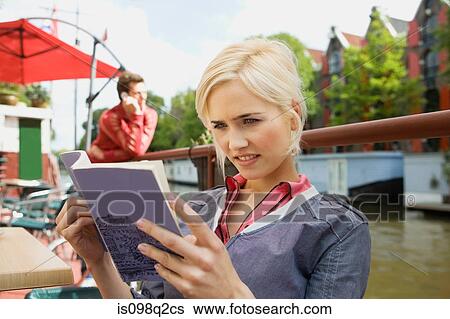 Stock Photograph - Woman with guidebook. Fotosearch