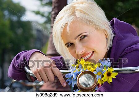 Stock Photo - Young woman with bicycle. Fotosearch