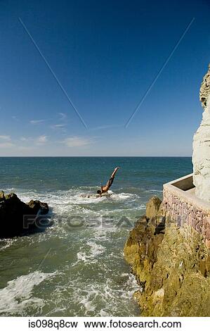 Stock Photo - Cliff diver at mazatlan. Fotosearch