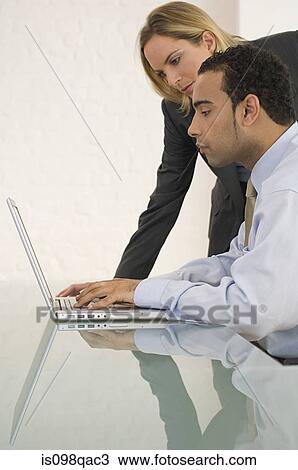 Stock Image - Colleagues with laptop. Fotosearch