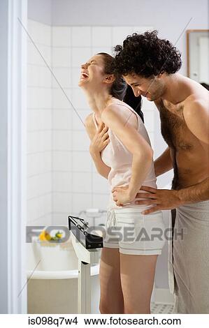 Couple laughing in the bathroom View Large Photo Image Picture - Couple laughing in the bathroom. Fotosearch