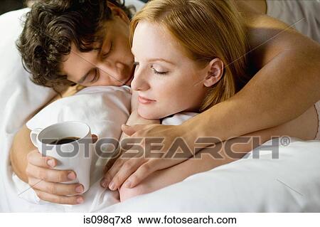Stock Photo - Couple relaxing in bed. Fotosearch