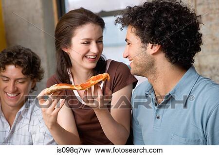 Friends eating pizza View Large Photo Image Stock Photo - Friends eating pizza. Fotosearch