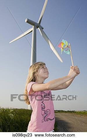 Girl with pinwheel by wind turbine View Large Photo Image Stock Image - Girl with pinwheel by wind turbine. Fotosearch