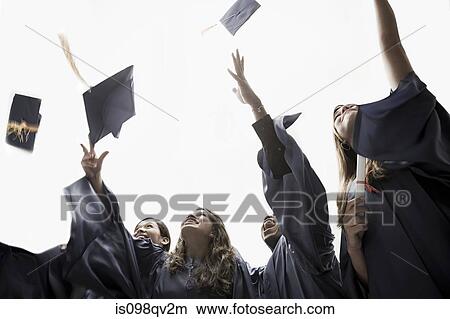 Graduates throwing mortarboards View Large Photo Image Picture - Graduates throwing mortarboards. Fotosearch