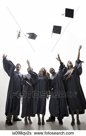 Graduates throwing mortarboards View Large Photo Image Stock Photograph - Graduates throwing mortarboards. Fotosearch