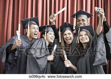 Stock Image - Graduating friends with camera. Fotosearch