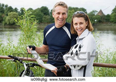 Stock Image - Mature couple looking at a map. Fotosearch