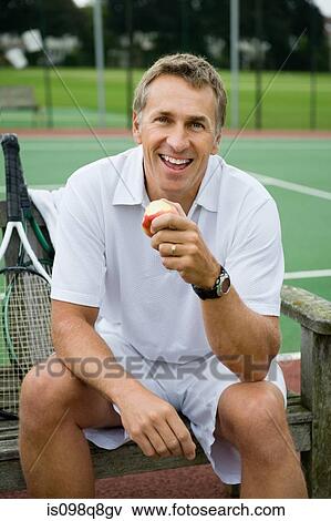 Mature man eating an apple View Large Photo Image Stock Photo - Mature man eating an apple. Fotosearch