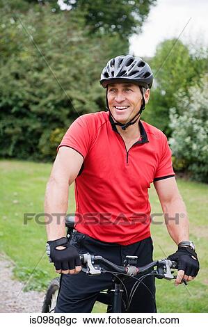 Stock Image - Mature man on a mountain bike. Fotosearch