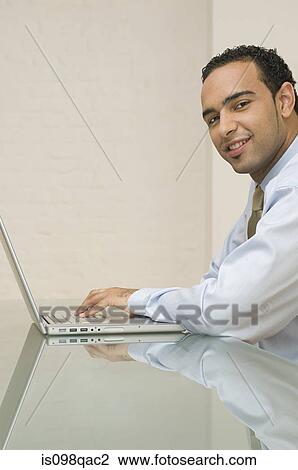 Office worker using laptop View Large Photo Image Stock Image - Office worker using laptop. Fotosearch