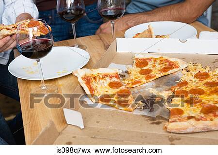 Pizza on a table View Large Photo Image Stock Photo - Pizza on a table. Fotosearch