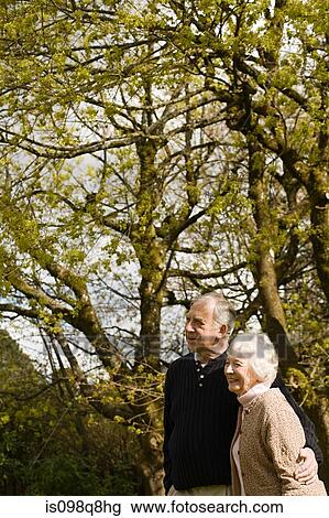Senior couple standing in the garden View Large Photo Image Stock Image - Senior couple standing in the garden. Fotosearch