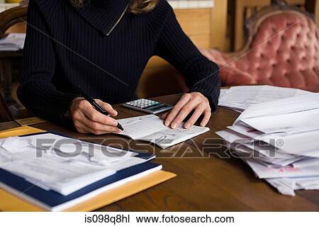 Stock Image - Senior woman working on her finances. Fotosearch