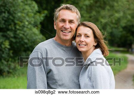 Smiling couple in tracksuits View Large Photo Image Stock Image - Smiling couple in tracksuits. Fotosearch