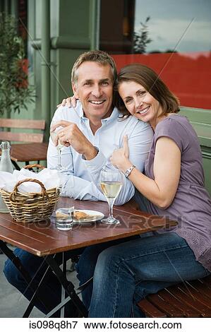 Smiling mature couple at a cafe View Large Photo Image Stock Photo - Smiling mature couple at a cafe. Fotosearch