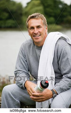 Smiling mature man wearing a tracksuit View Large Photo Image Stock Image - Smiling mature man wearing a tracksuit. Fotosearch