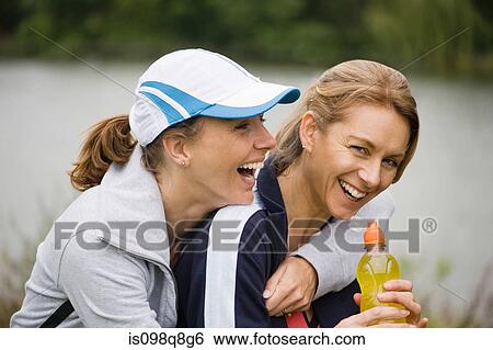 Two mature female friends laughing View Large Photo Image Stock Photograph - Two mature female friends laughing. Fotosearch