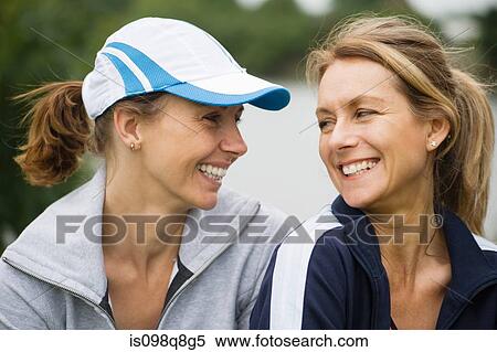 Two mature female friends smiling View Large Photo Image Stock Photography - Two mature female friends smiling. Fotosearch