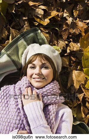 Woman lying on leaves View Large Photo Image Picture - Woman lying on leaves. Fotosearch