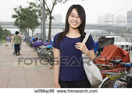 Stock Photograph - Young woman in street. Fotosearch