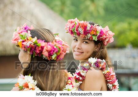 Stock Photo - Young women with flowers in hair in moorea. Fotosearch