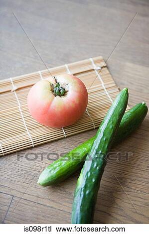 Stock Image - A beef tomato and cucumbers. Fotosearch
