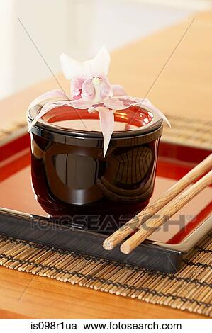 Stock Image - A dish and chopsticks on a table in a restaurant. Fotosearch