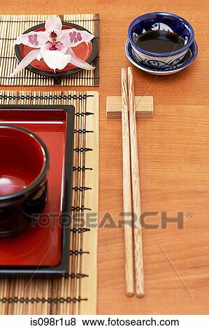 Stock Photo - A dish and chopsticks on a table in a restaurant. Fotosearch