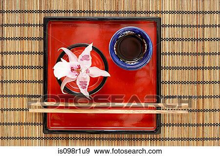 A dish and chopsticks on a table in a restaurant View Large Photo Image Stock Photo - A dish and chopsticks on a table in a restaurant. Fotosearch