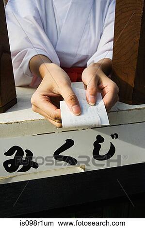 A woman holding a omikuji View Large Photo Image Picture - A woman holding a omikuji. Fotosearch