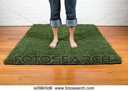 A woman standing on grass View Large Photo Image Stock Photo - A woman standing on grass. Fotosearch