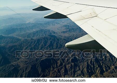 Airplane over mountains in china View Large Photo Image Stock Photo - Airplane over mountains in china. Fotosearch