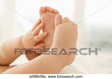 Stock Image - Babys hands and feet. Fotosearch