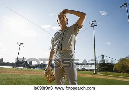 Stock Image - Baseball pitcher looking. Fotosearch