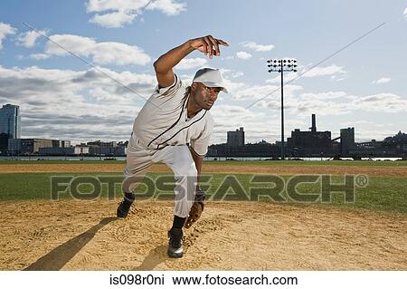 Stock Image - Baseball pitcher throwing a ball. Fotosearch