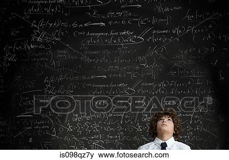 Boy in front of blackboard View Large Photo Image Stock Photo - Boy in front of blackboard. Fotosearch