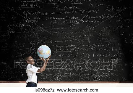 Boy with globe in front of blackboard View Large Photo Image Stock Photo - Boy with globe in front of blackboard. Fotosearch