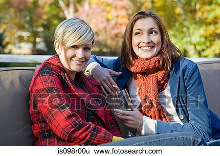 Stock Photograph - Friends sitting outside. Fotosearch
