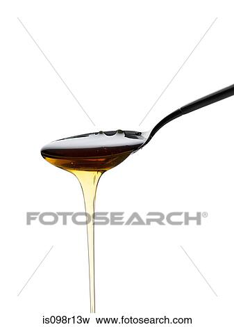 Honey pouring off a spoon View Large Photo Image Stock Photo - Honey pouring off a spoon. Fotosearch