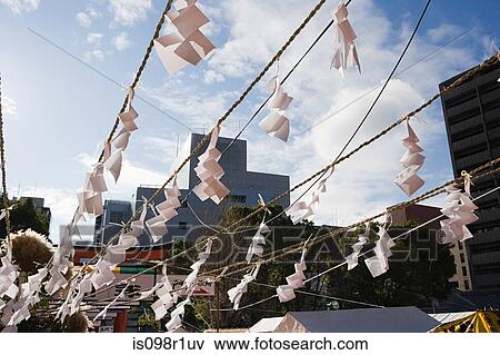 Omikuji on a rope at a shrine View Large Photo Image Stock Photo - Omikuji on a rope at a shrine. Fotosearch