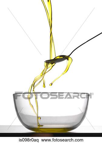 Stock Photography - Pouring honey into a bowl. Fotosearch