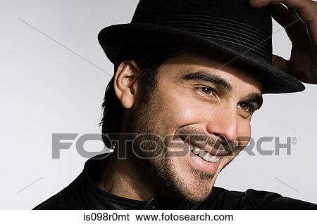 Profile of a young man wearing a fedora View Large Photo Image Stock Photograph - Profile of a young man wearing a fedora. Fotosearch