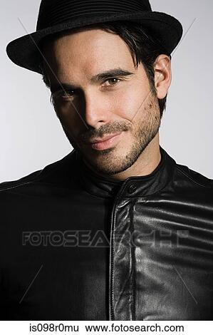 Profile of a young man wearing a fedora View Large Photo Image Stock Photograph - Profile of a young man wearing a fedora. Fotosearch