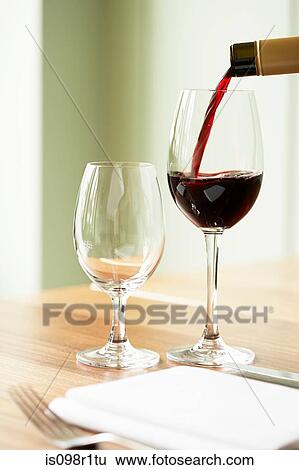 Red wine being poured into a wine glass View Large Photo Image Stock Photograph - Red wine being poured into a wine glass. Fotosearch